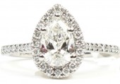 PLATINUM ENGAGEMENT RING WITH .91CT CENTER PEAR DIAMOND SURROUNDED BY A DIAMOND HALO